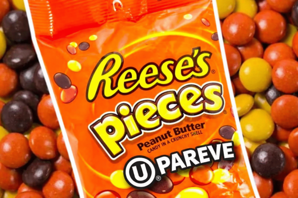 Official OU kosher advisory image confirming Reese’s Pieces Peanut Butter Candy has been reformulated from dairy to pareve, with no milk listed in ingredients or allergen statement and note about packaging still showing OU-D temporarily