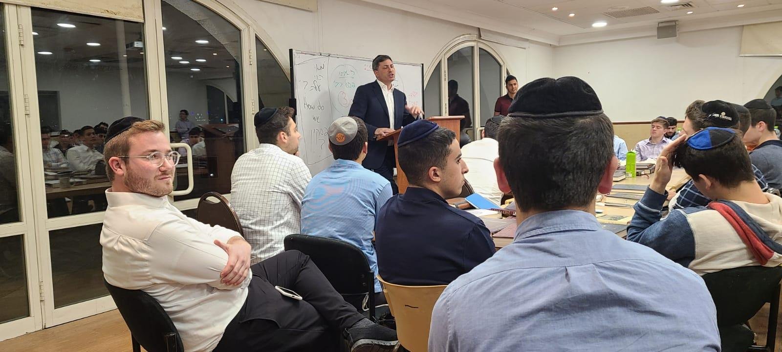 Reishit students listening as Rabbi Eli Stefansky introduces the Maseches Megillah Daf Yomi challenge
